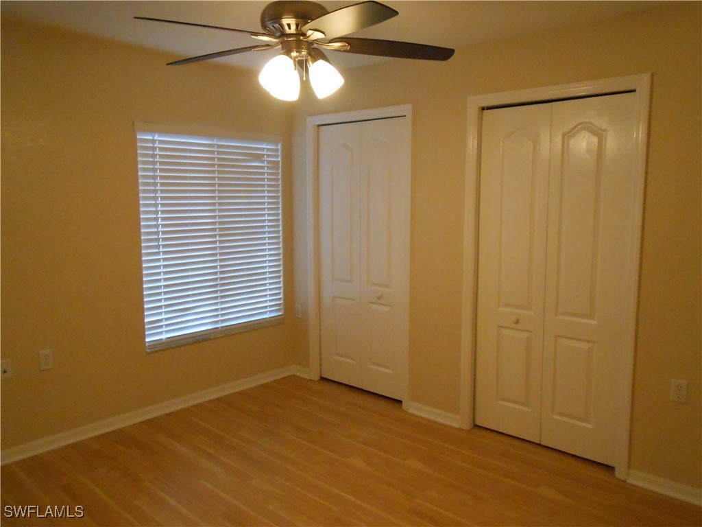9409 Ivy Brook Run, Unit 1303 Fort Myers, FL 33913 - Photo 21 of 25 a view of an empty room with wooden floor and a window