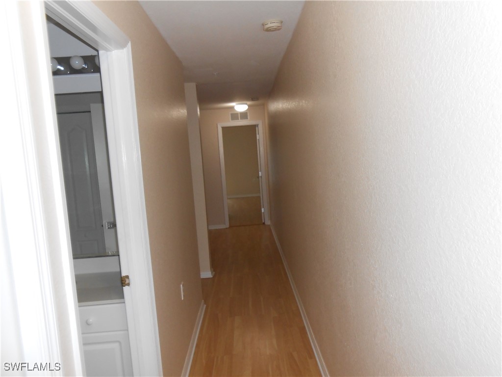 9409 Ivy Brook Run, Unit 1303 Fort Myers, FL 33913 - Photo 23 of 25 a view of a hallway
