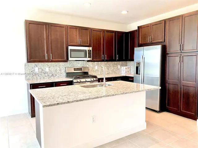 a view of a kitchen with a sink and a window