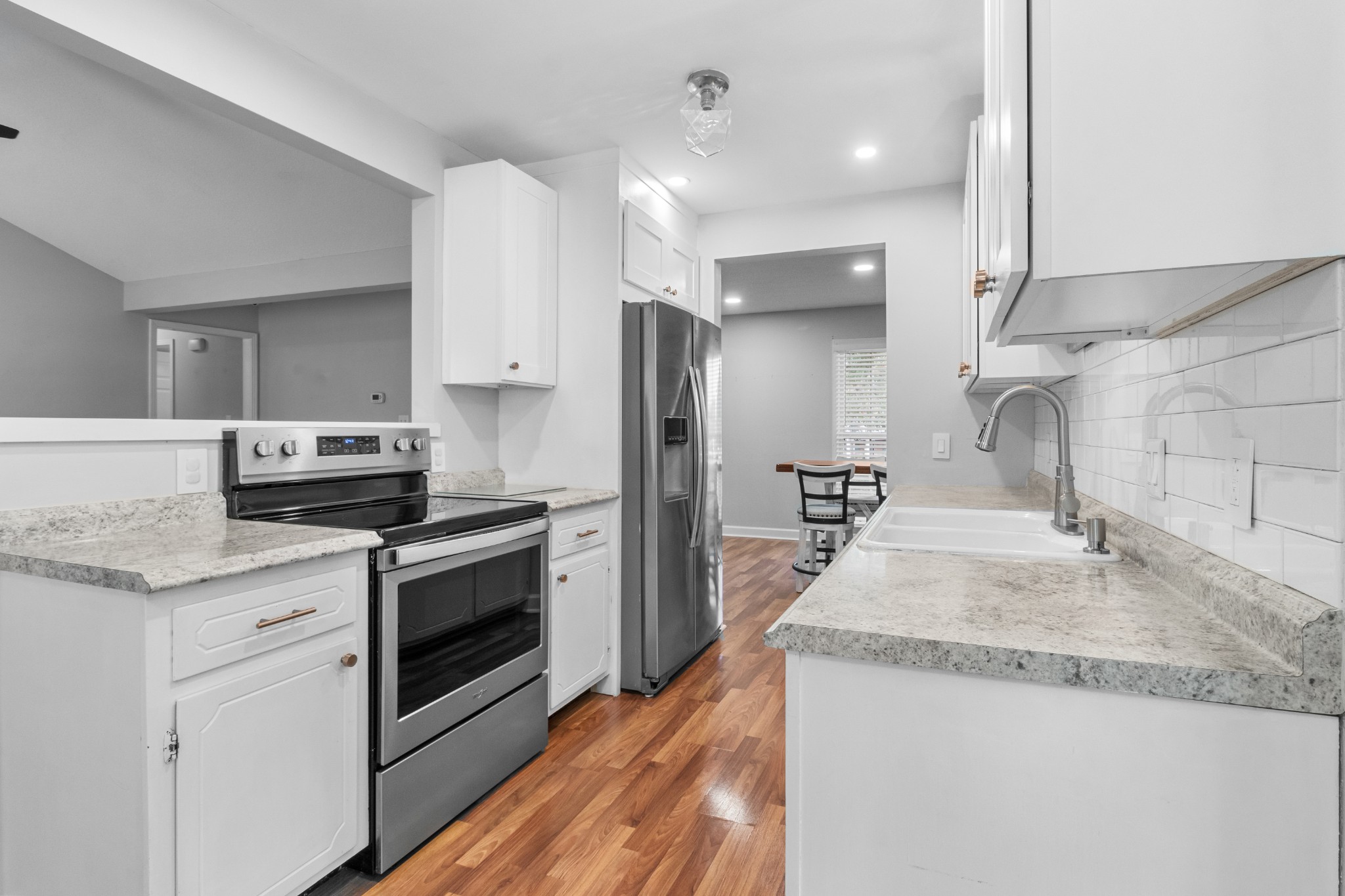 521 Sango Road Clarksville, TN 37043 - Photo 11 of 46 a kitchen with granite countertop kitchen island wooden cabinets and stainless steel appliances