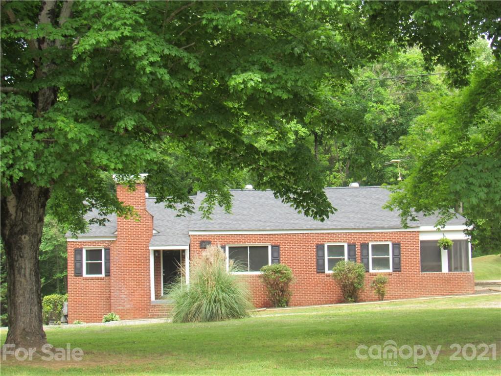 301 Highway 221 Rutherfordton, NC 28139 - Photo 1 of 28 a front view of a house with a garden