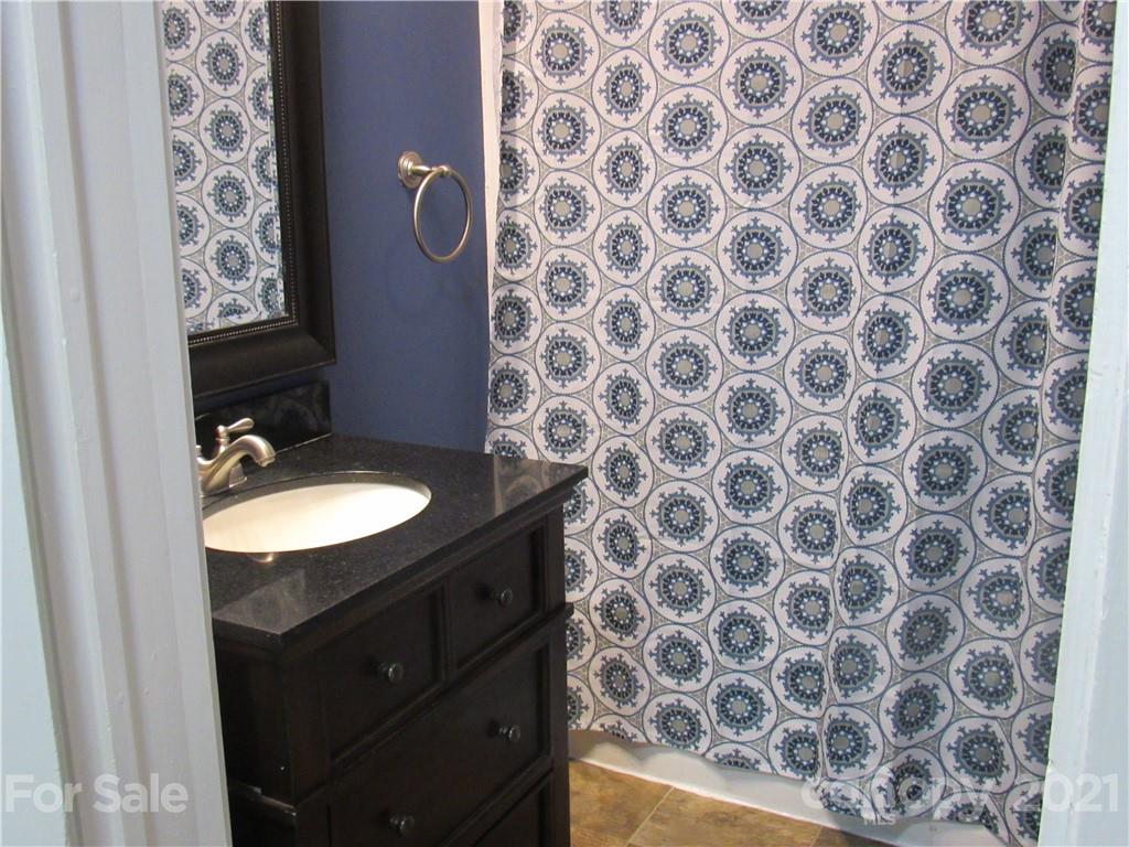 301 Highway 221 Rutherfordton, NC 28139 - Photo 4 of 28 a bathroom with a granite countertop sink and a mirror