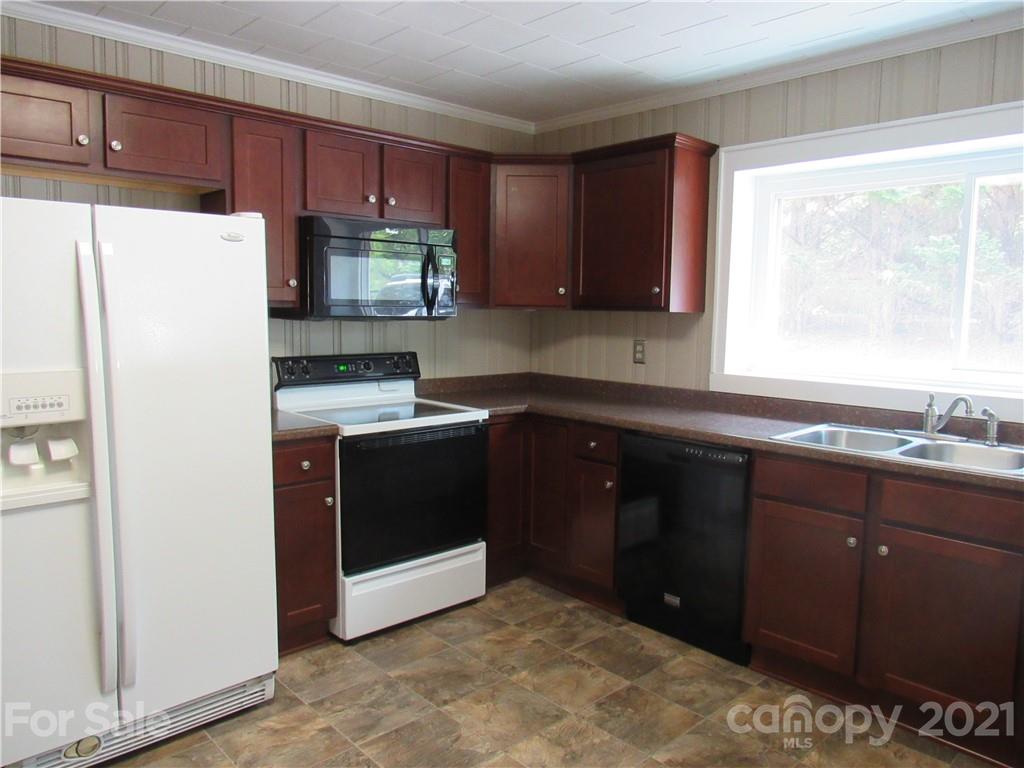 301 Highway 221 Rutherfordton, NC 28139 - Photo 7 of 28 a kitchen with a refrigerator and a sink