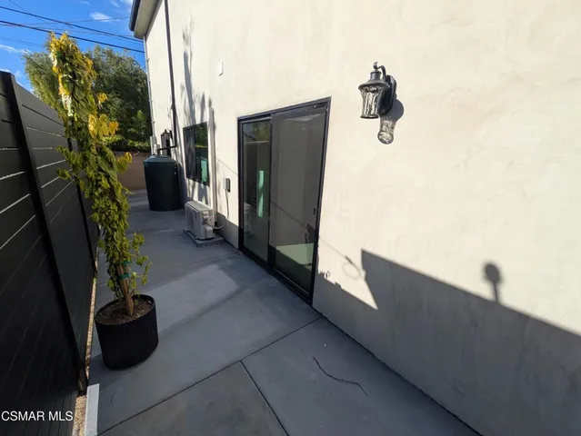 a picture of a bench in front of a white house