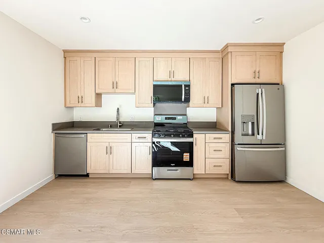 a kitchen with a refrigerator stove and microwave