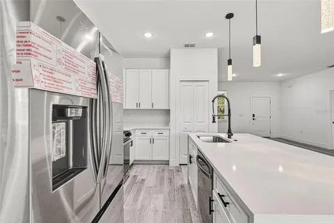 a kitchen with a sink stainless steel appliances and cabinets