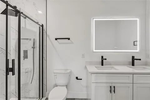 a bathroom with a toilet sink and shower