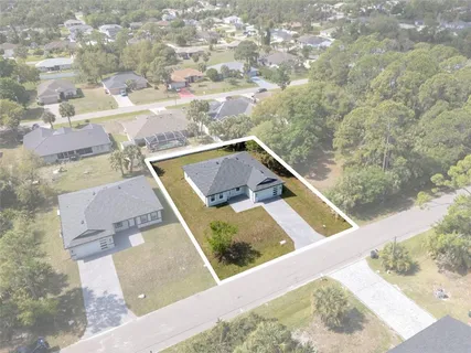 an aerial view of a house with yard swimming pool and outdoor seating