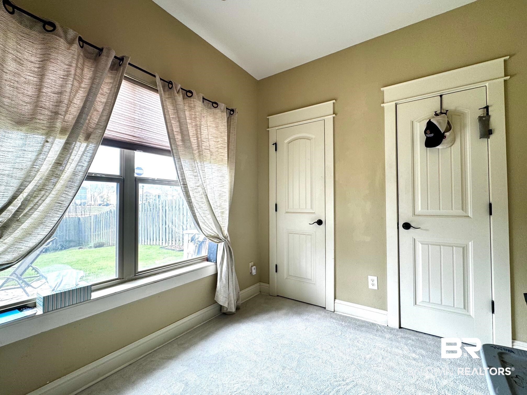 1030 Crown Walk Drive Foley, AL 36535 - Photo 27 of 40 Unfurnished bedroom with baseboards and light carpet