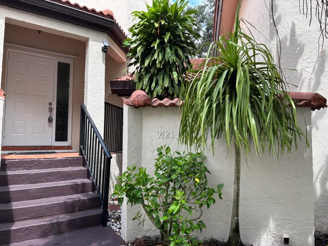 a view of a house with a flower garden
