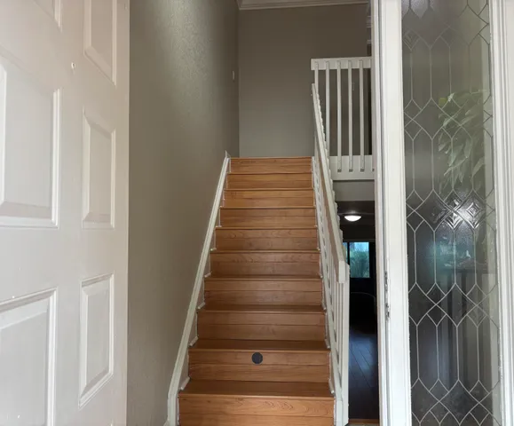 a view of entryway and hall with wooden floor