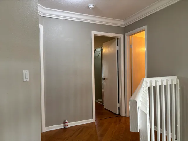 a view of a livingroom with wooden floor and a window