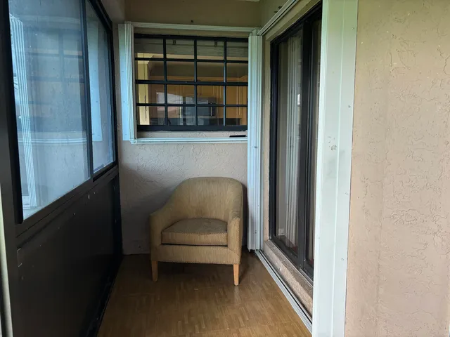 a living room with a chair and a window