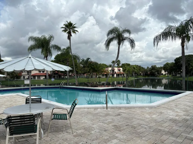 a view of swimming pool with outdoor seating and plants