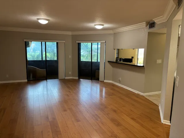 a view of a livingroom with wooden floor and furniture