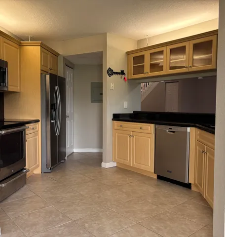 a kitchen with stainless steel appliances granite countertop a stove and a refrigerator