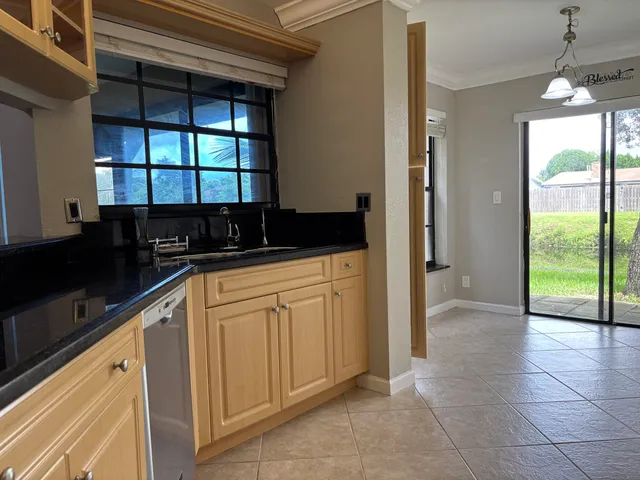 a kitchen with a refrigerator and a sink