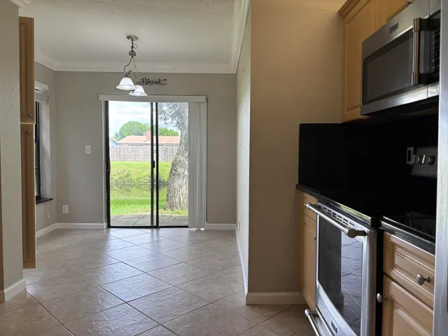 a view of an empty room with a fireplace and a flat screen tv