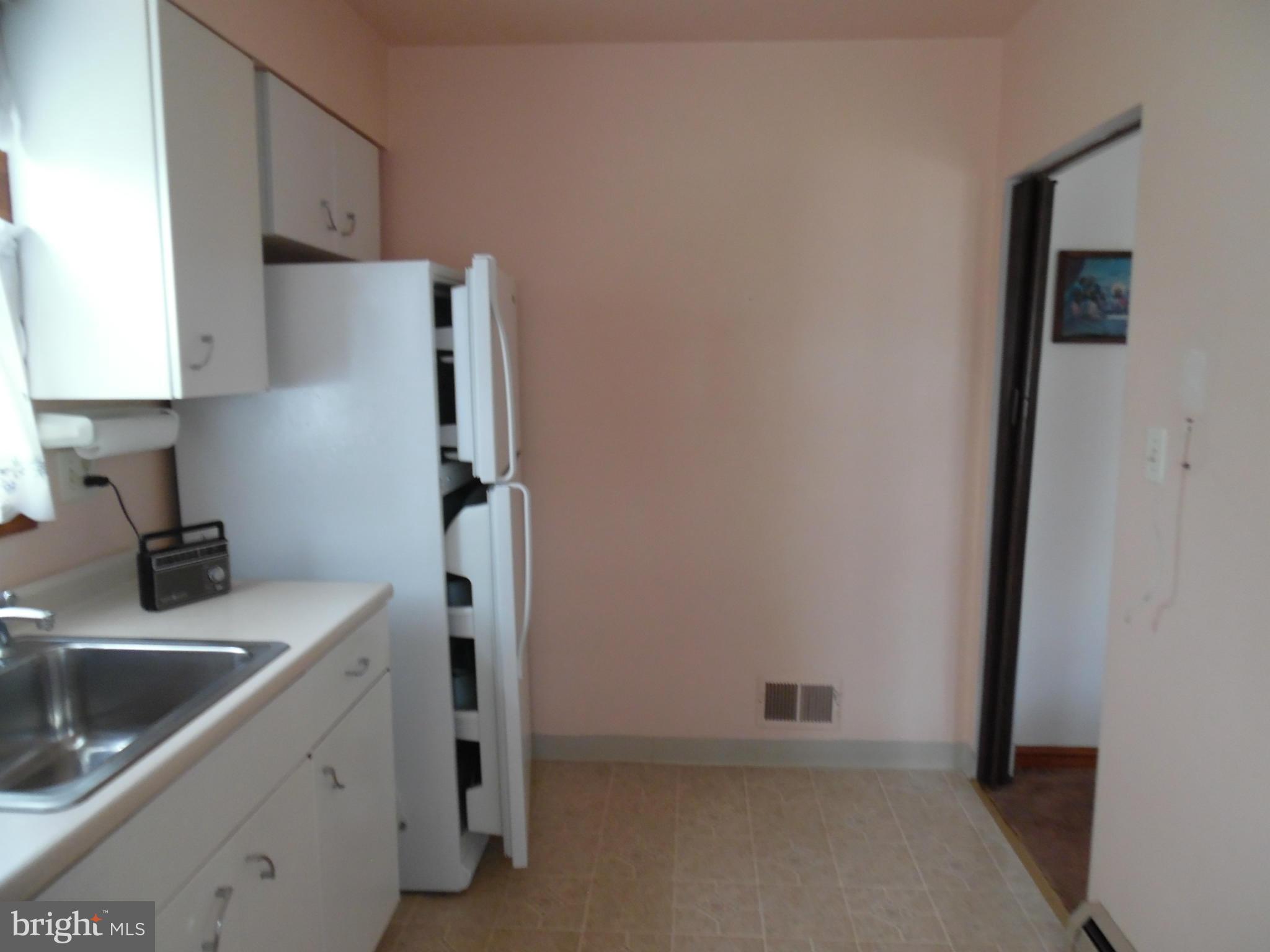 1800 Forrest Road Baltimore, MD 21234 - Photo 7 of 17 a kitchen with a sink and cabinets