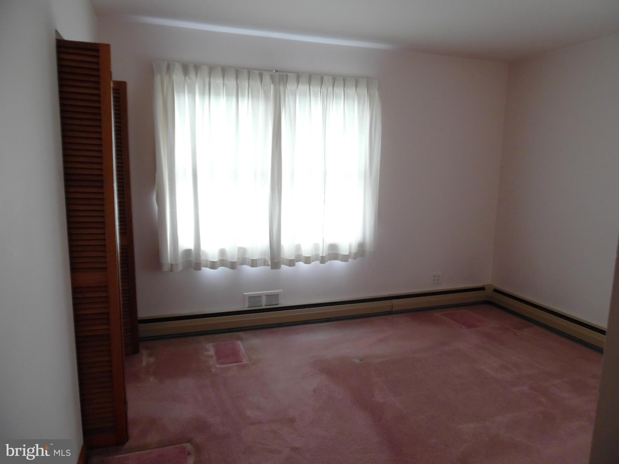 1800 Forrest Road Baltimore, MD 21234 - Photo 10 of 17 an empty room with wooden floor and windows