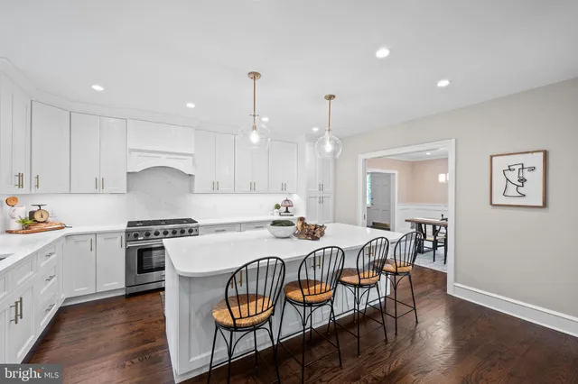 a kitchen with granite countertop a sink stainless steel appliances and cabinets