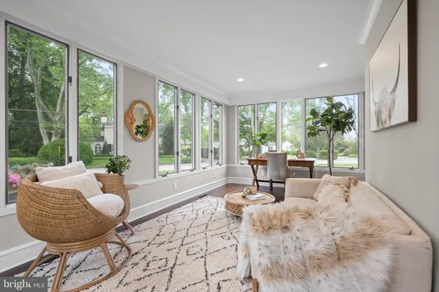 a bathroom with a granite countertop toilet a sink and a window