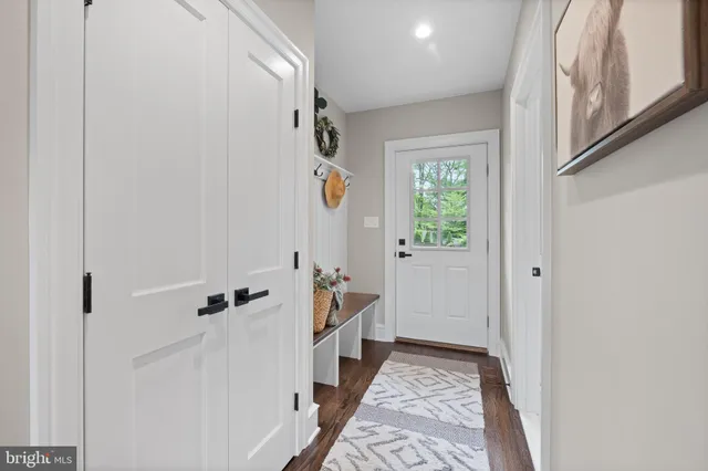 a view of entryway with wooden floor and stairs