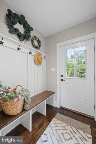 a view of entryway with wooden floor and stairs