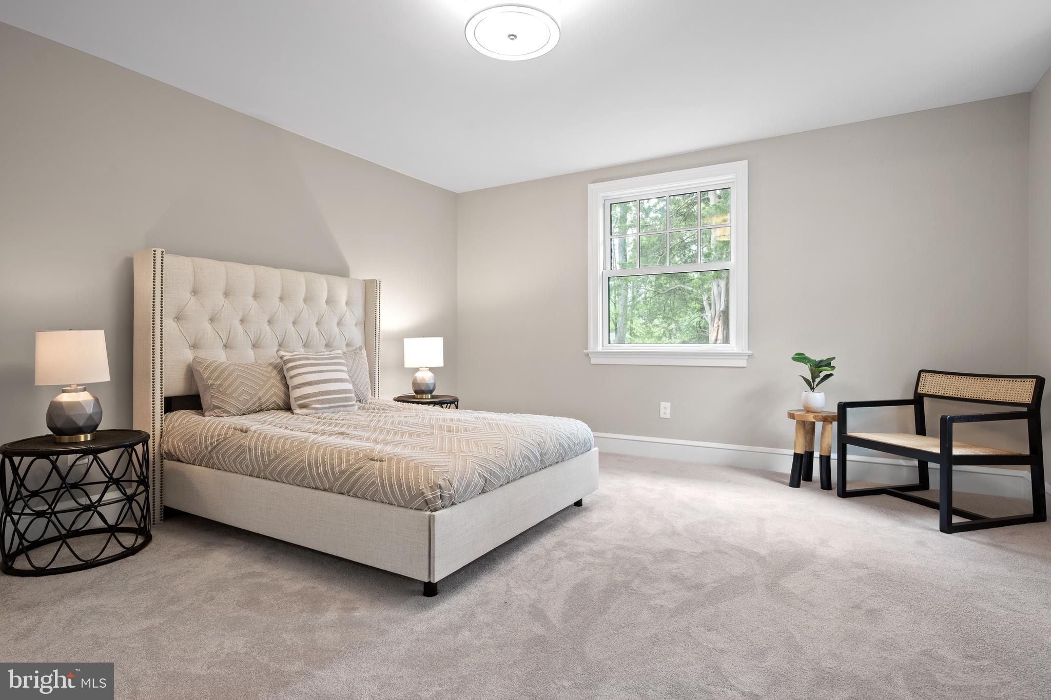 200 Hilldale Road, Unit 1 Villanova, PA 19085 - Photo 28 of 58 a spacious bedroom with a bed a couch and two windows