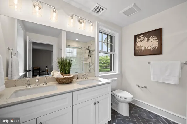 a spacious bedroom with a bed and a large window