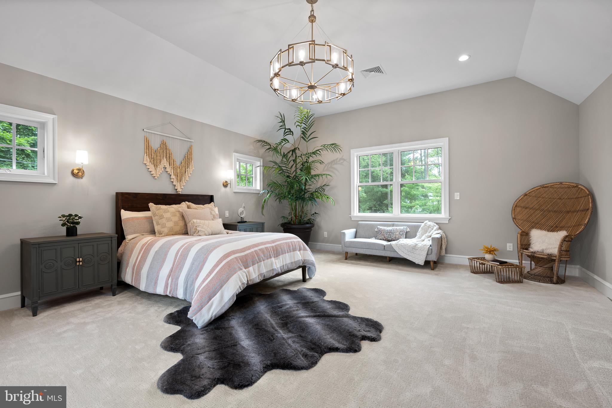 200 Hilldale Road, Unit 1 Villanova, PA 19085 - Photo 33 of 58 a spacious bedroom with a bed and a chandelier