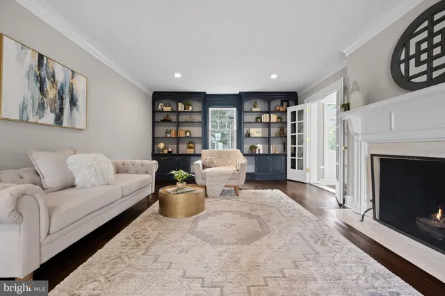 a living room with furniture and a book shelf