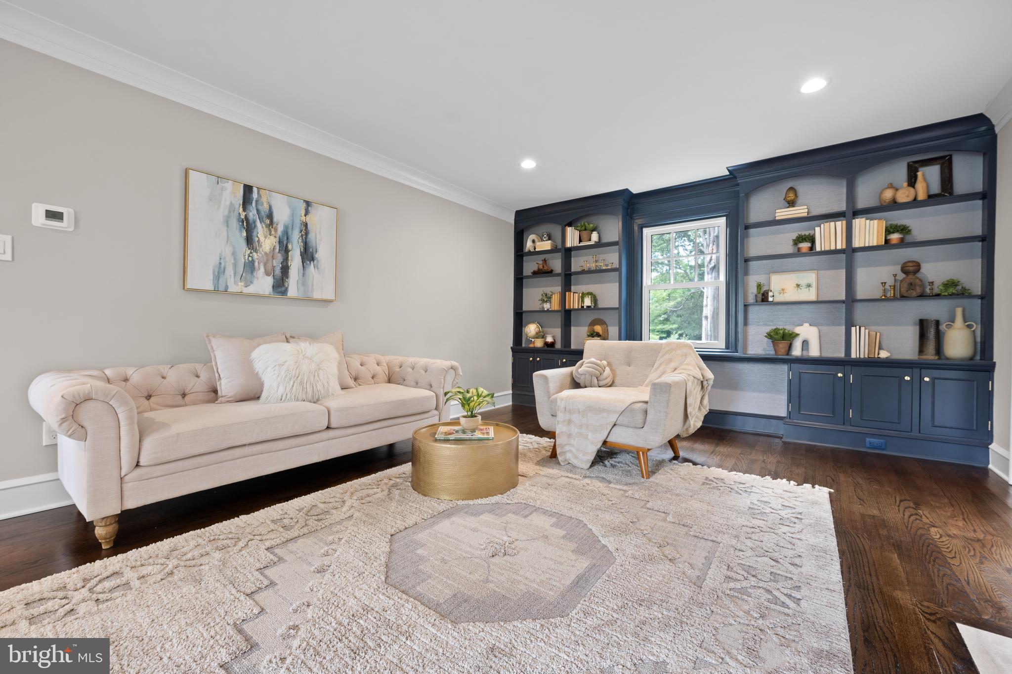 200 Hilldale Road, Unit 1 Villanova, PA 19085 - Photo 6 of 58 a living room with furniture and a book shelf