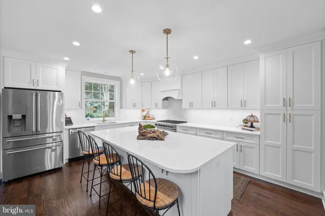 a kitchen with granite countertop lots of wooden furniture dining table and chairs