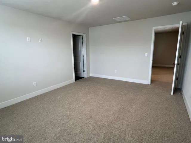 a view of an empty room and closet area