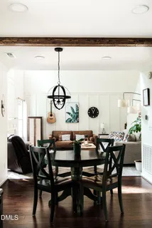 a view of a dining room with furniture wooden floor and a chandelier