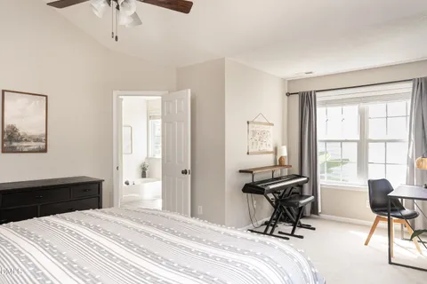a view of a house with a potted plant and floor to ceiling window