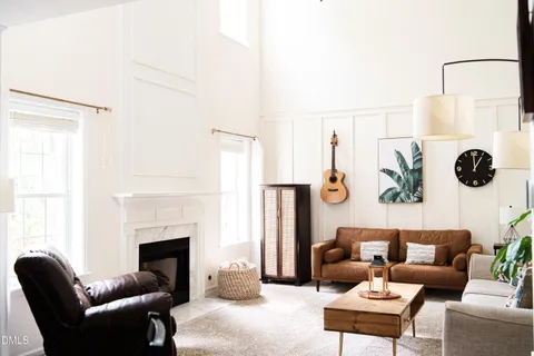 a living room with furniture and wall painting