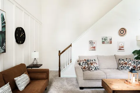 a view of a dining room with furniture and chandelier