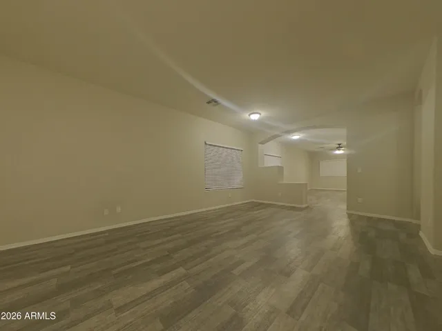 a view of an empty room and wooden floor