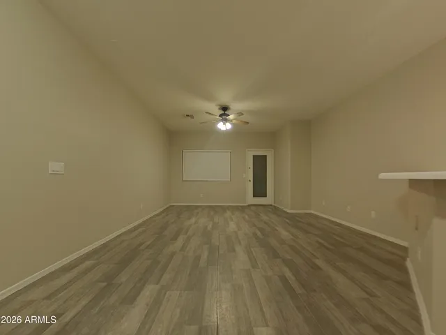 a view of a room with wooden floor