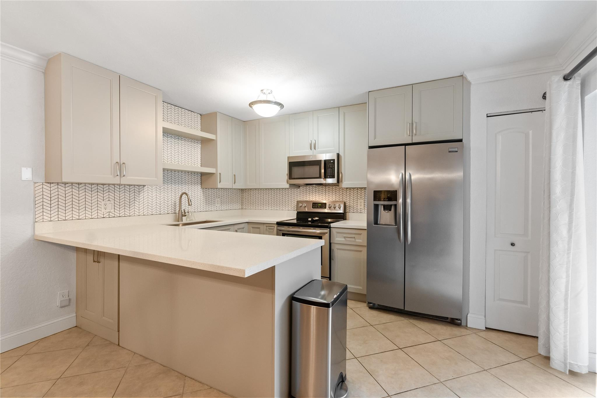 2061 Southwest 90th Avenue, Unit B17 Davie, FL 33324 - Photo 11 of 38 a kitchen with a sink stainless steel appliances and cabinets