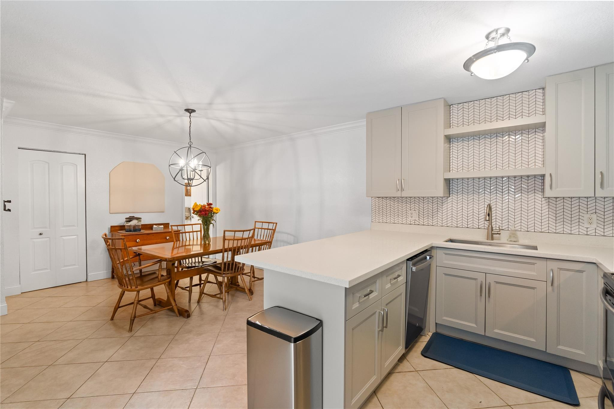 2061 Southwest 90th Avenue, Unit B17 Davie, FL 33324 - Photo 13 of 38 a kitchen that has a sink a table and chairs in it