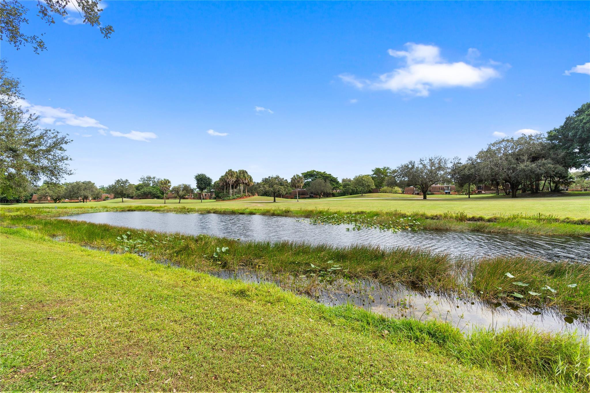 2061 Southwest 90th Avenue, Unit B17 Davie, FL 33324 - Photo 33 of 38 a view of a lake with houses in the background
