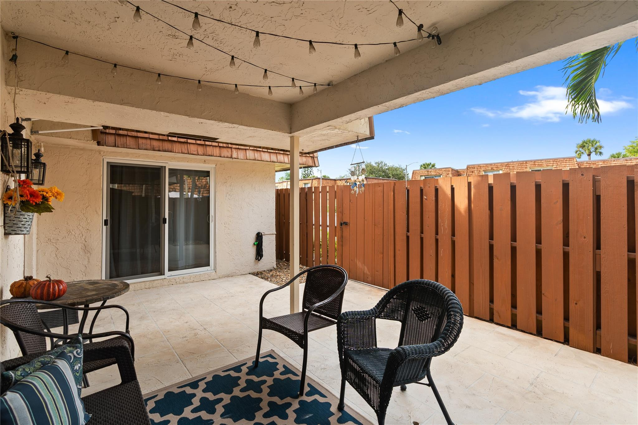 2061 Southwest 90th Avenue, Unit B17 Davie, FL 33324 - Photo 4 of 38 a balcony with table and chairs