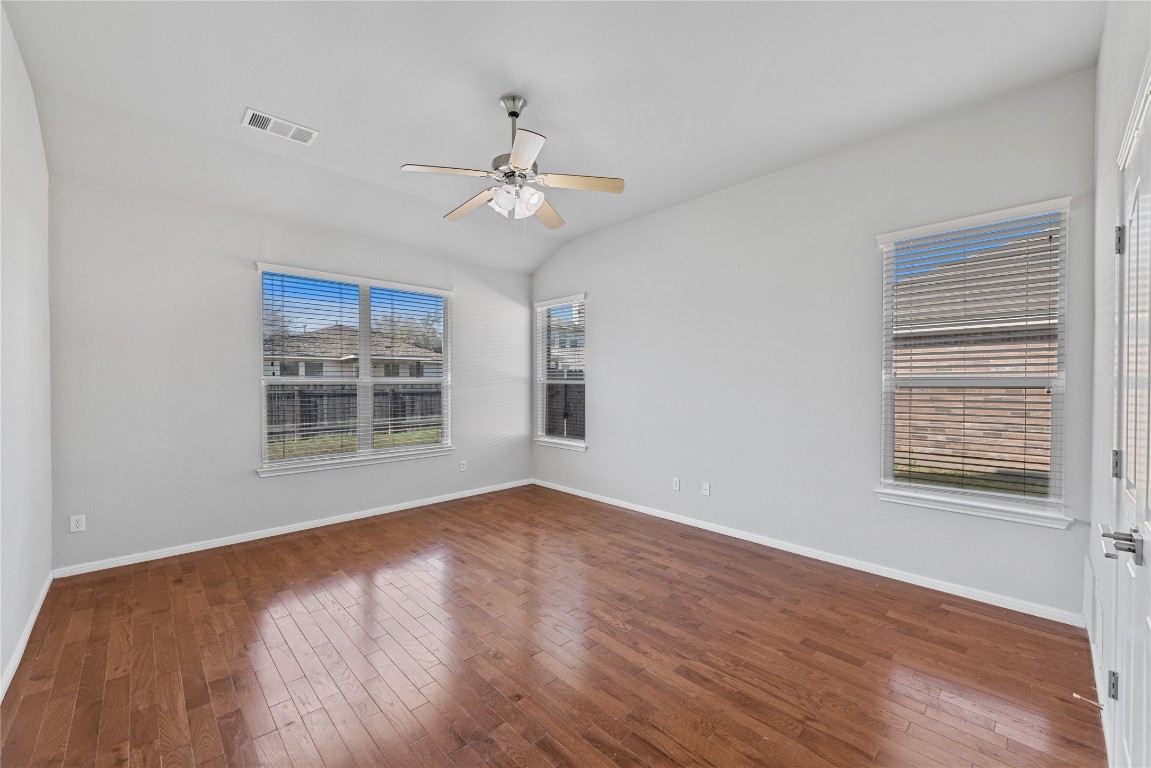 12017 Lansdowne Road Austin, TX 78754 - Photo 11 of 30 a view of an empty room with a window and wooden floor