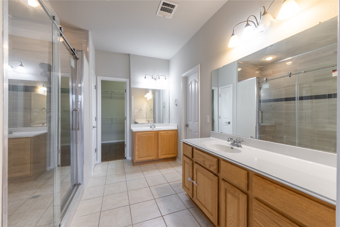 12017 Lansdowne Road Austin, TX 78754 - Photo 12 of 30 a spacious bathroom with a tub sink shower and mirror
