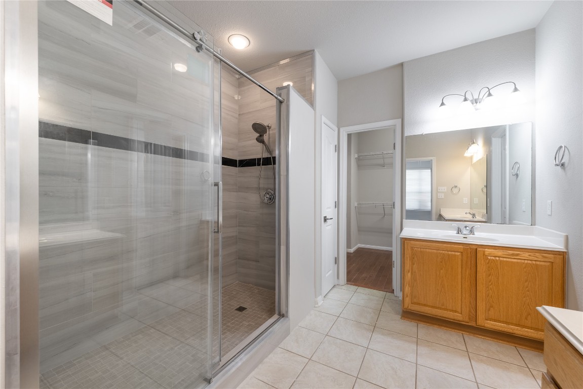 12017 Lansdowne Road Austin, TX 78754 - Photo 13 of 30 a bathroom with a bathtub and a shower