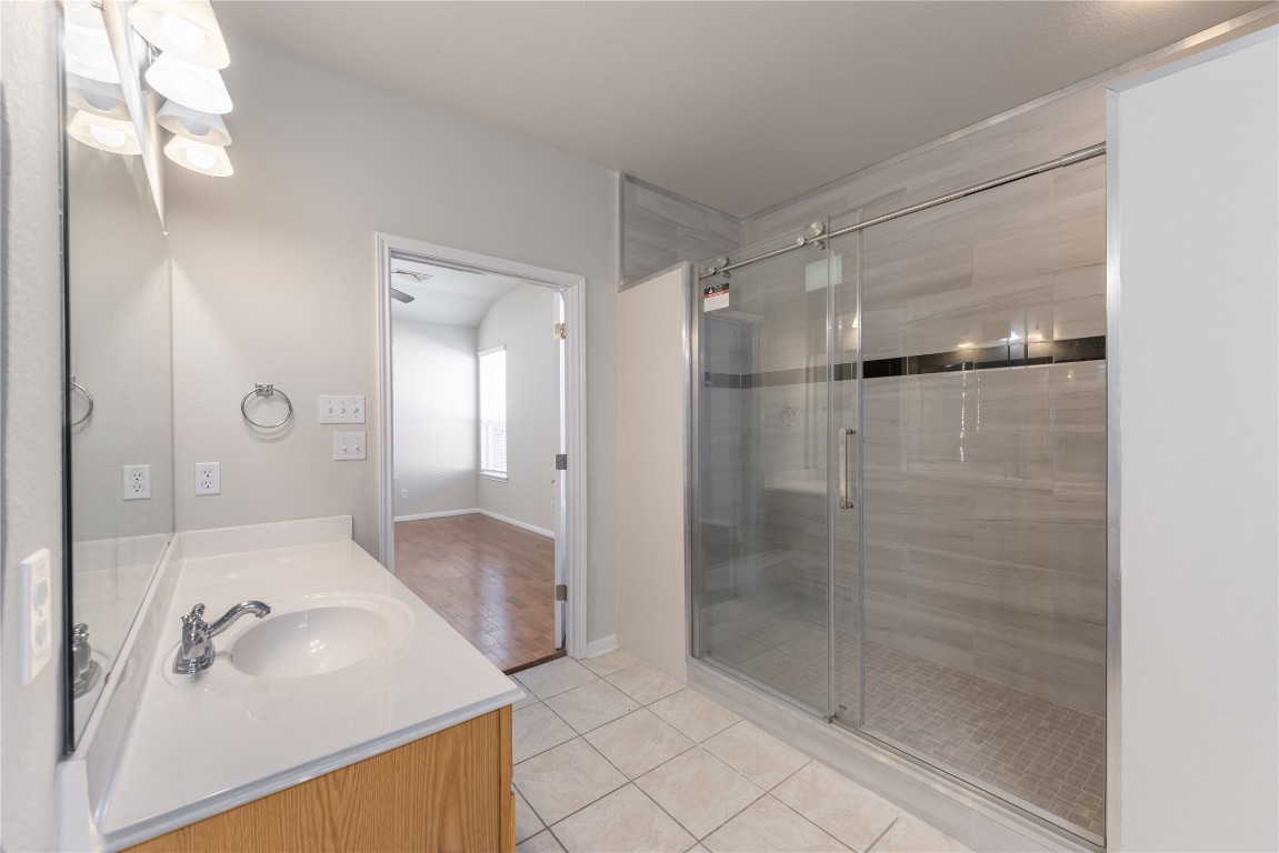 12017 Lansdowne Road Austin, TX 78754 - Photo 14 of 30 a bathroom with a shower sink and mirror