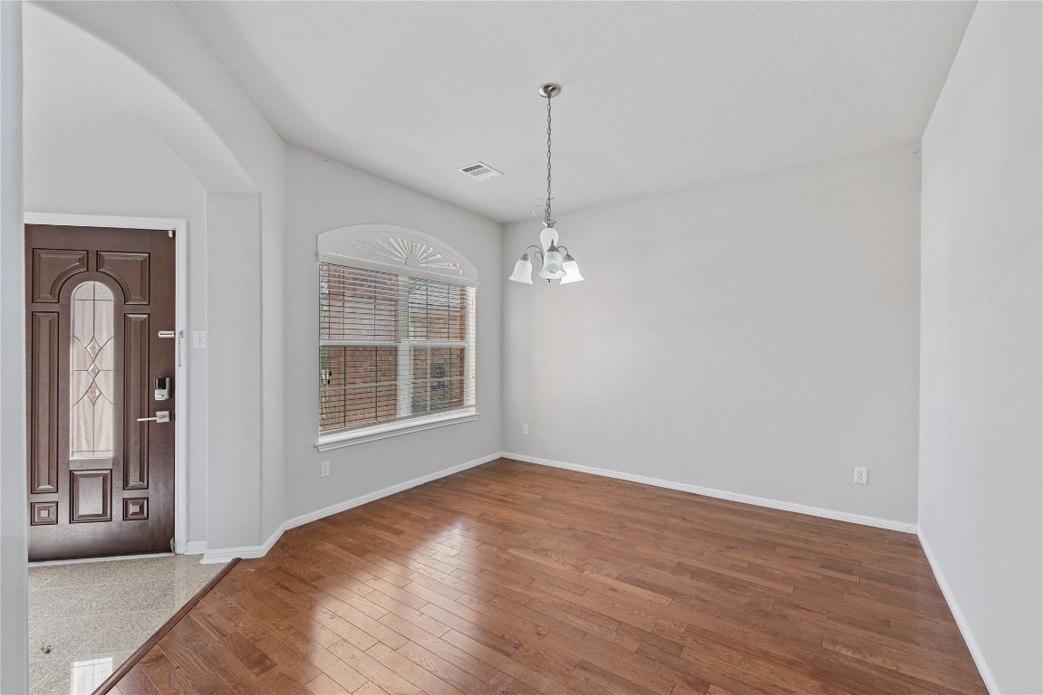 12017 Lansdowne Road Austin, TX 78754 - Photo 16 of 30 a view of empty room with wooden floor and fan